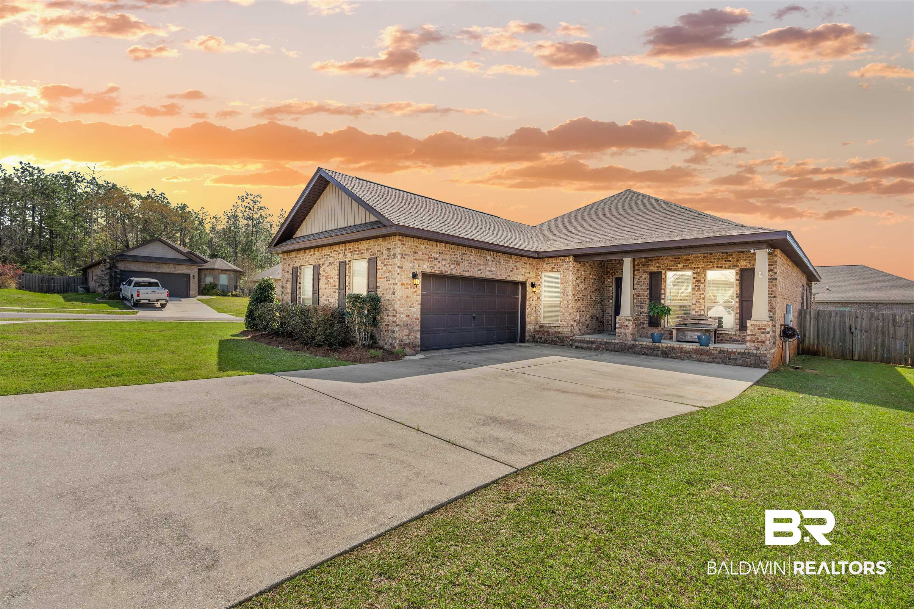 11712 Alameda Court Spanish Fort, AL 36527 - Photo 1 of 27 View of front of house featuring a garage and a yard