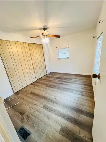 a view of a room with wooden floor