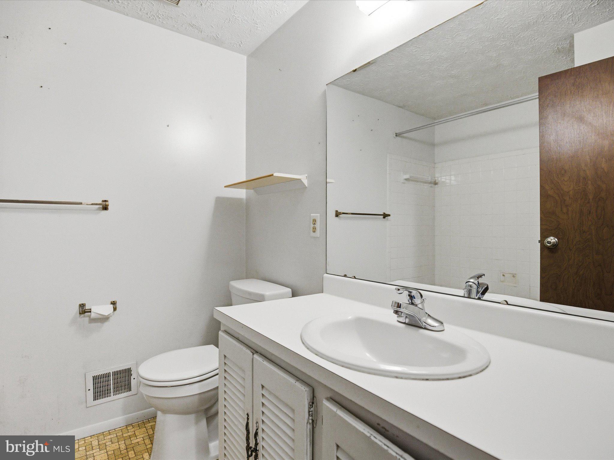 6314 West Vein Road Bowie, MD 20720 - Photo 16 of 28 a bathroom with a sink toilet and a mirror