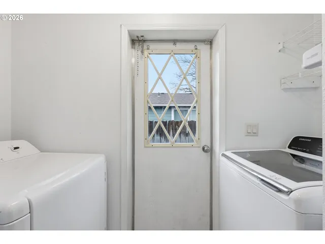 a living room with a bed furniture and a window