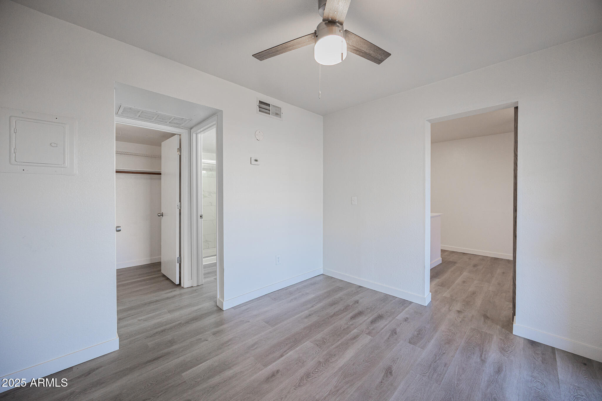 3131 West Cochise Drive, Unit 129 Phoenix, AZ 85051 - Photo 11 of 17 a view of an empty room with wooden floor