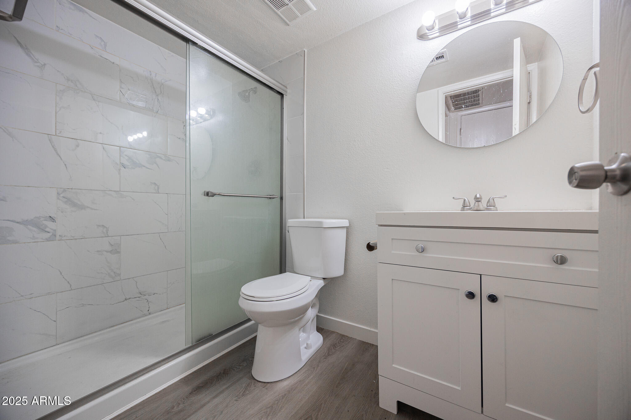 3131 West Cochise Drive, Unit 129 Phoenix, AZ 85051 - Photo 13 of 17 a bathroom with a sink a toilet and a mirror