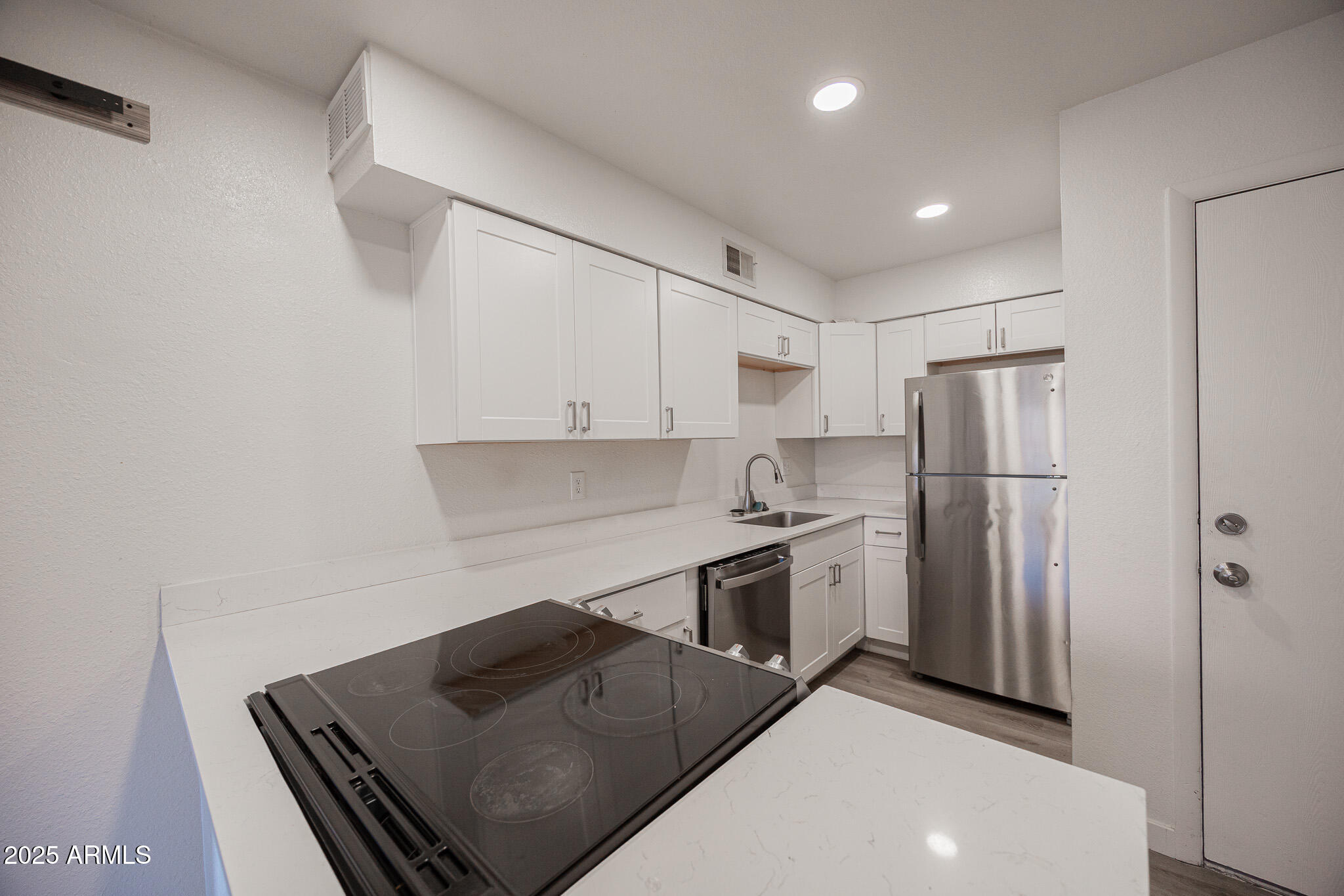 3131 West Cochise Drive, Unit 129 Phoenix, AZ 85051 - Photo 8 of 17 a kitchen with stainless steel appliances granite countertop a refrigerator and a stove top oven