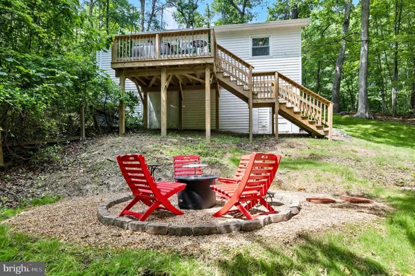 a view of house with backyard and seating area