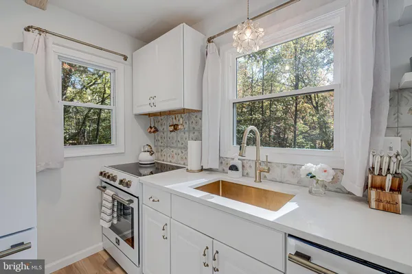 a kitchen with a sink appliances and a window