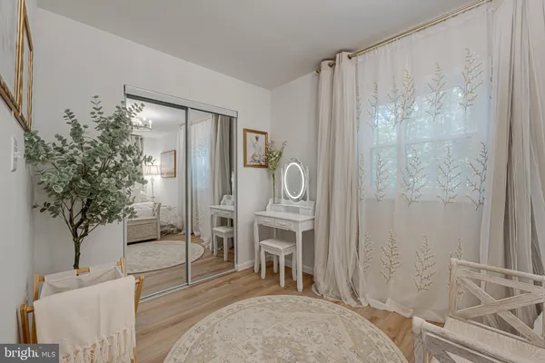 a living room with furniture a large window and potted plants