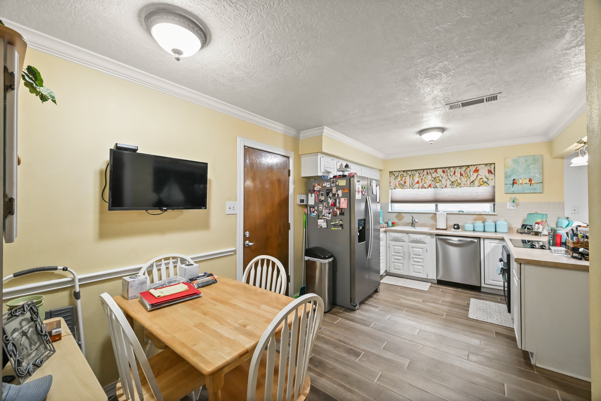 20135 Fox Grove Lane Humble, TX 77338 - Photo 14 of 34 a open kitchen with stainless steel appliances granite countertop a refrigerator a stove top oven a sink dishwasher and a dining table with wooden floor