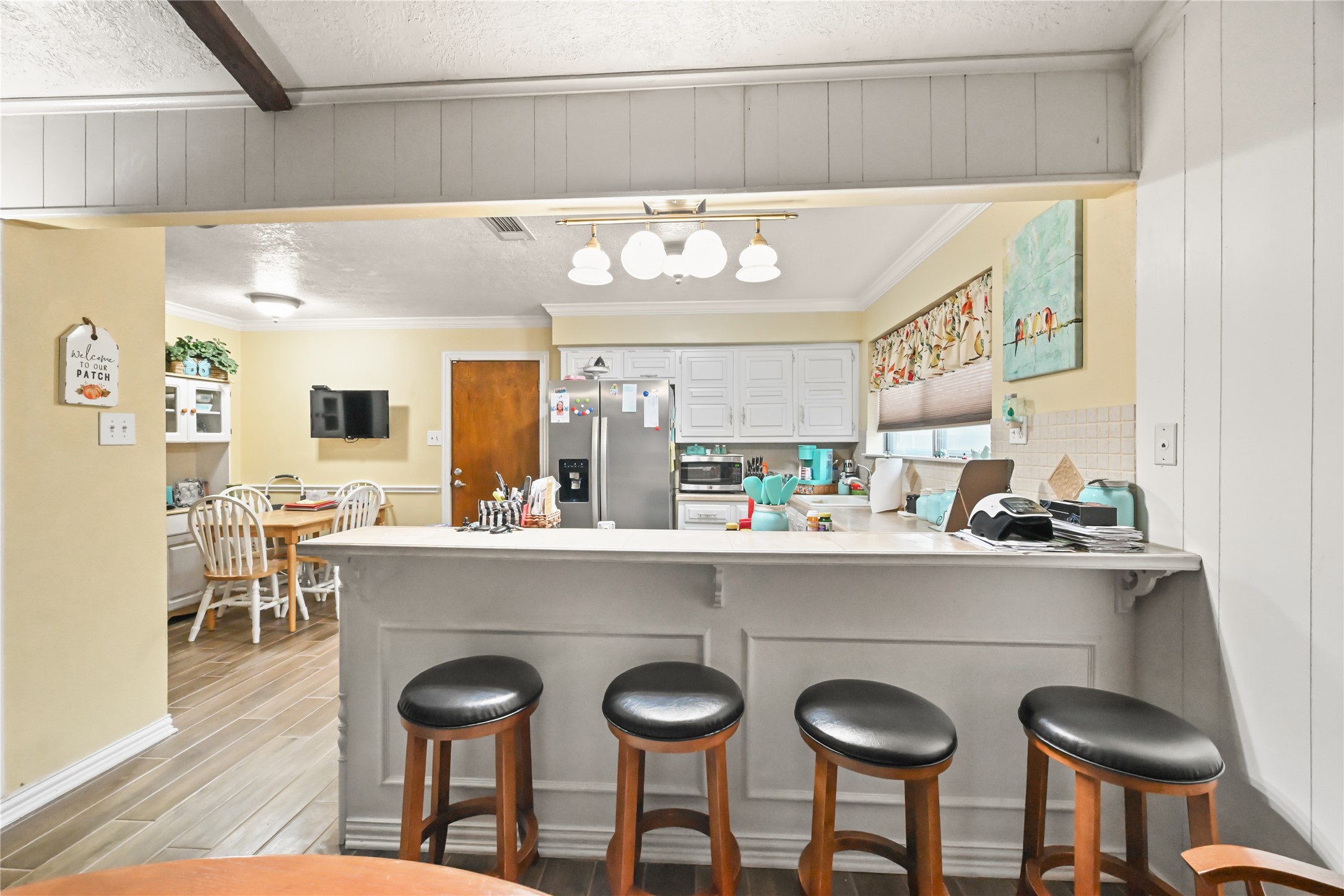20135 Fox Grove Lane Humble, TX 77338 - Photo 17 of 34 a kitchen with stainless steel appliances a dining table and chairs