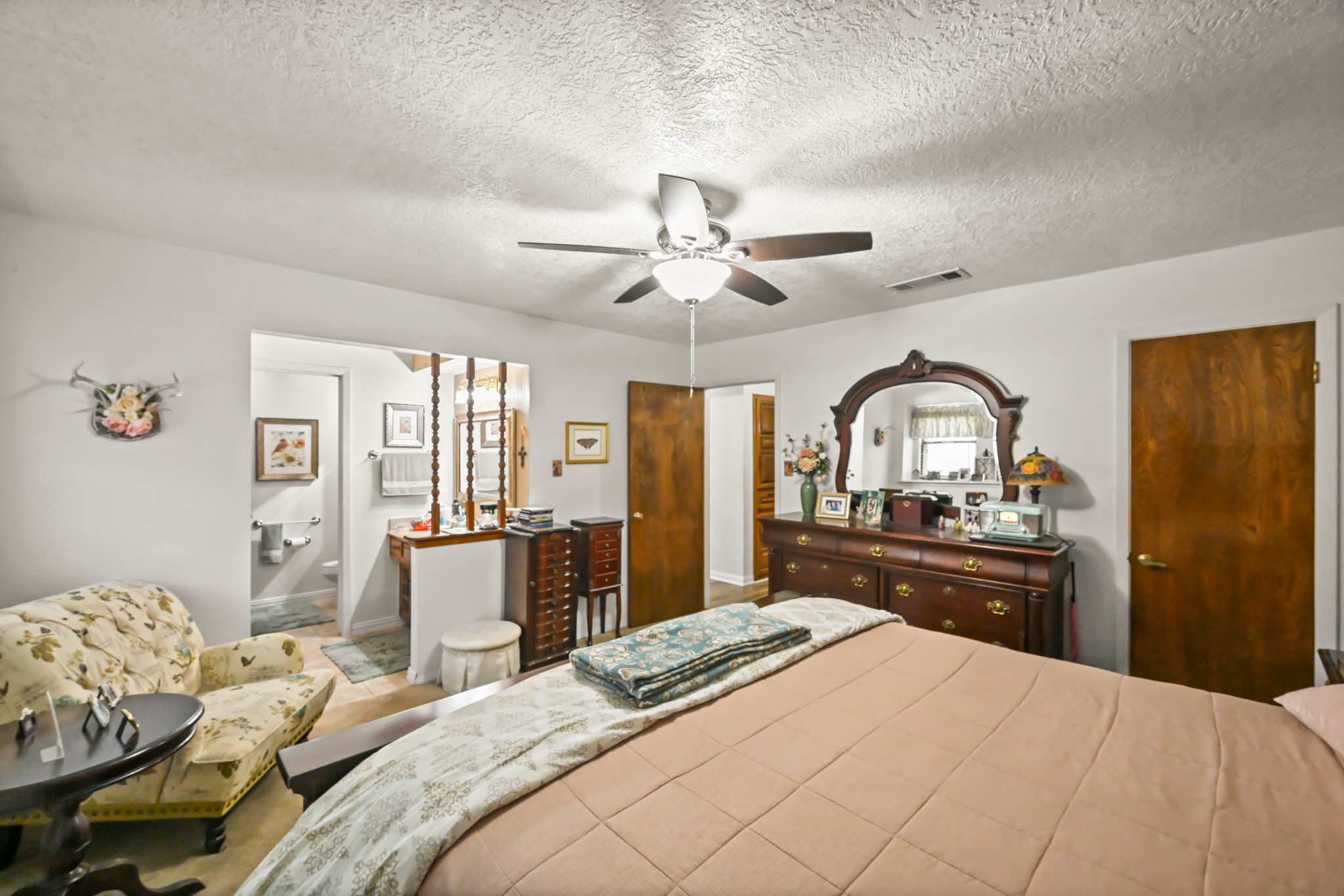 20135 Fox Grove Lane Humble, TX 77338 - Photo 20 of 34 a bedroom with a bed and dresser with mirror