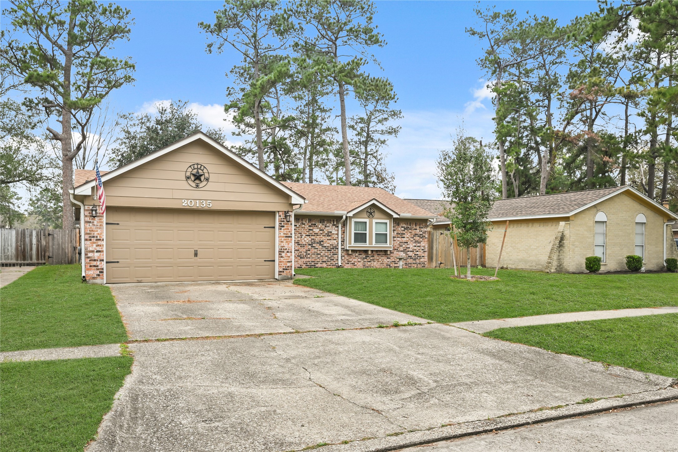 20135 Fox Grove Lane Humble, TX 77338 - Photo 2 of 34 a front view of a house with a yard and garage
