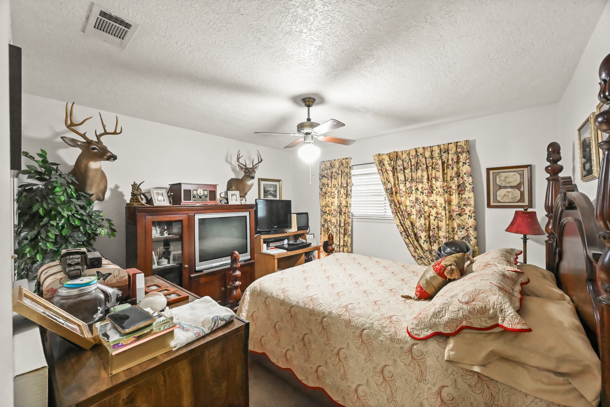 20135 Fox Grove Lane Humble, TX 77338 - Photo 22 of 34 a bed room with a bed and a chandelier