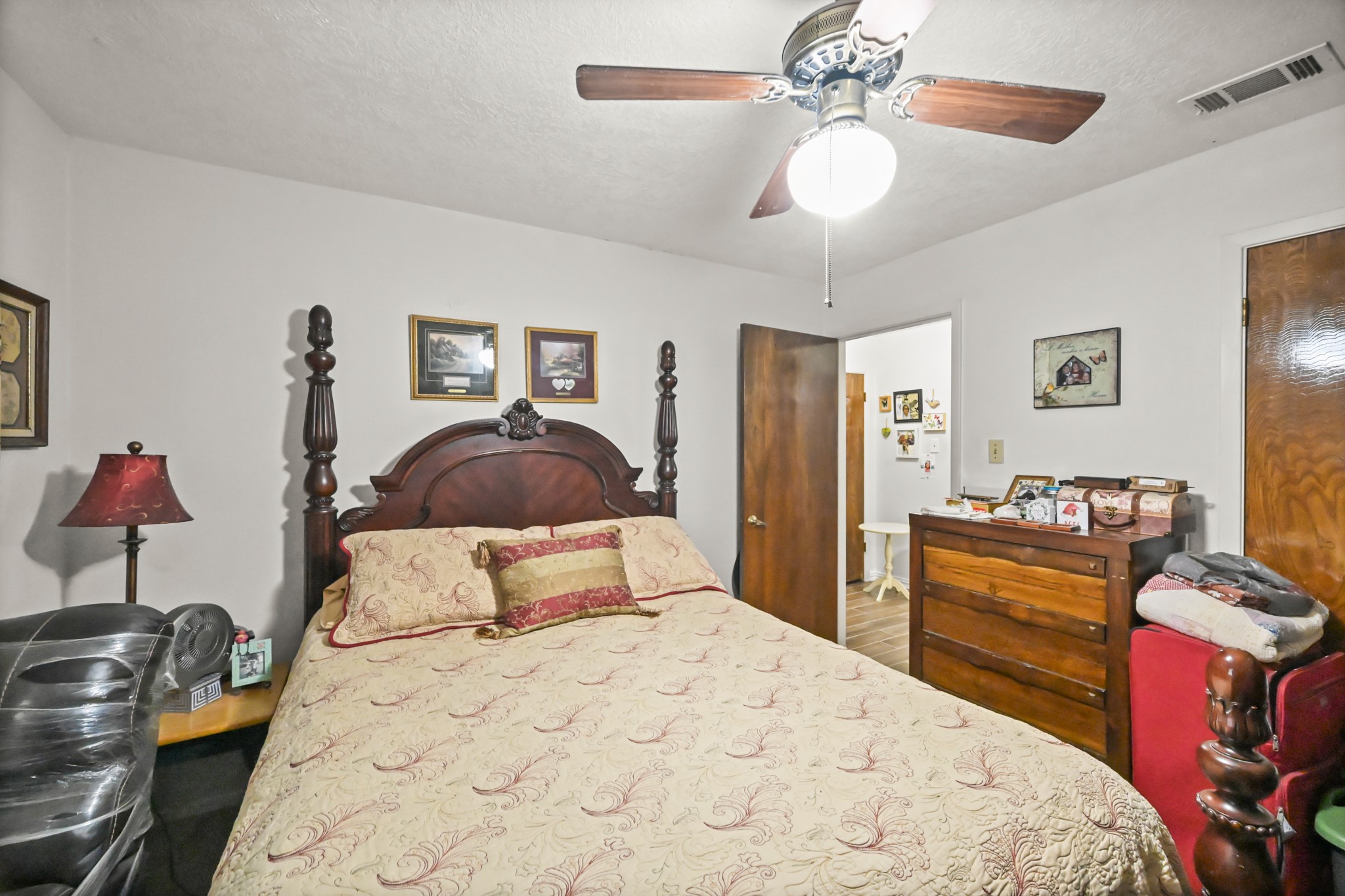 20135 Fox Grove Lane Humble, TX 77338 - Photo 23 of 34 a bedroom with a bed and a chandelier