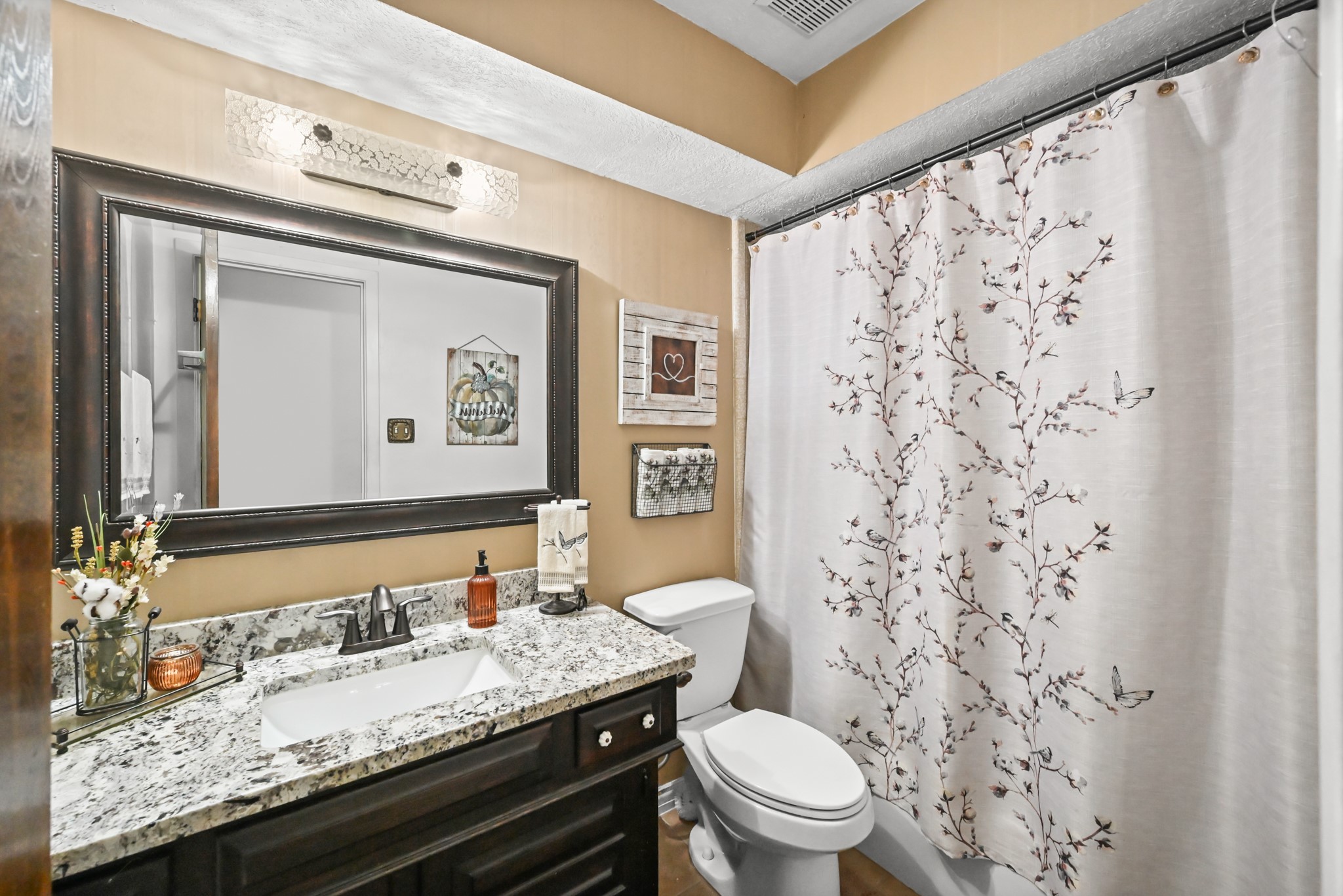 20135 Fox Grove Lane Humble, TX 77338 - Photo 24 of 34 a bathroom with a granite countertop sink and a mirror