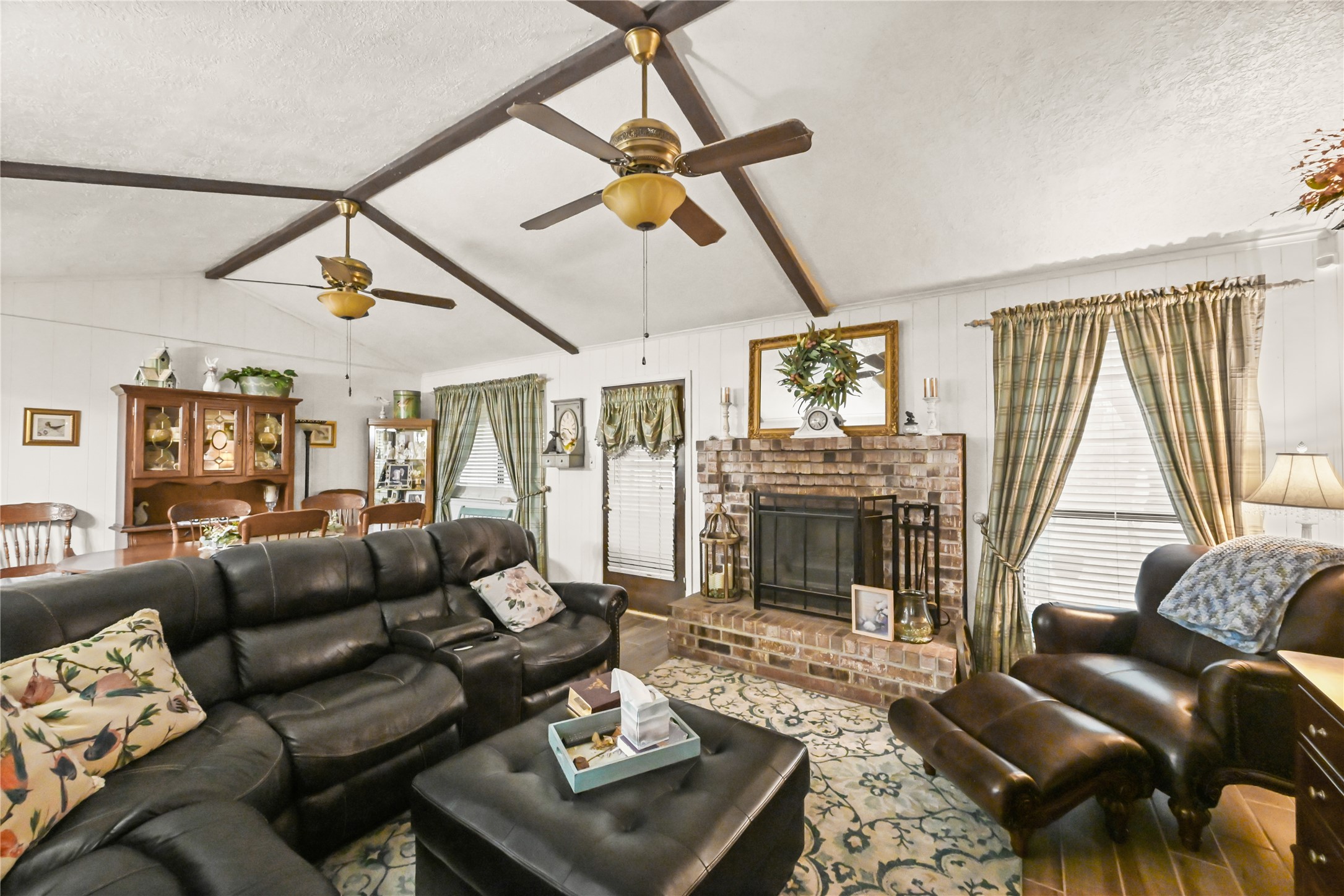 20135 Fox Grove Lane Humble, TX 77338 - Photo 4 of 34 a living room with furniture a fireplace and a flat screen tv