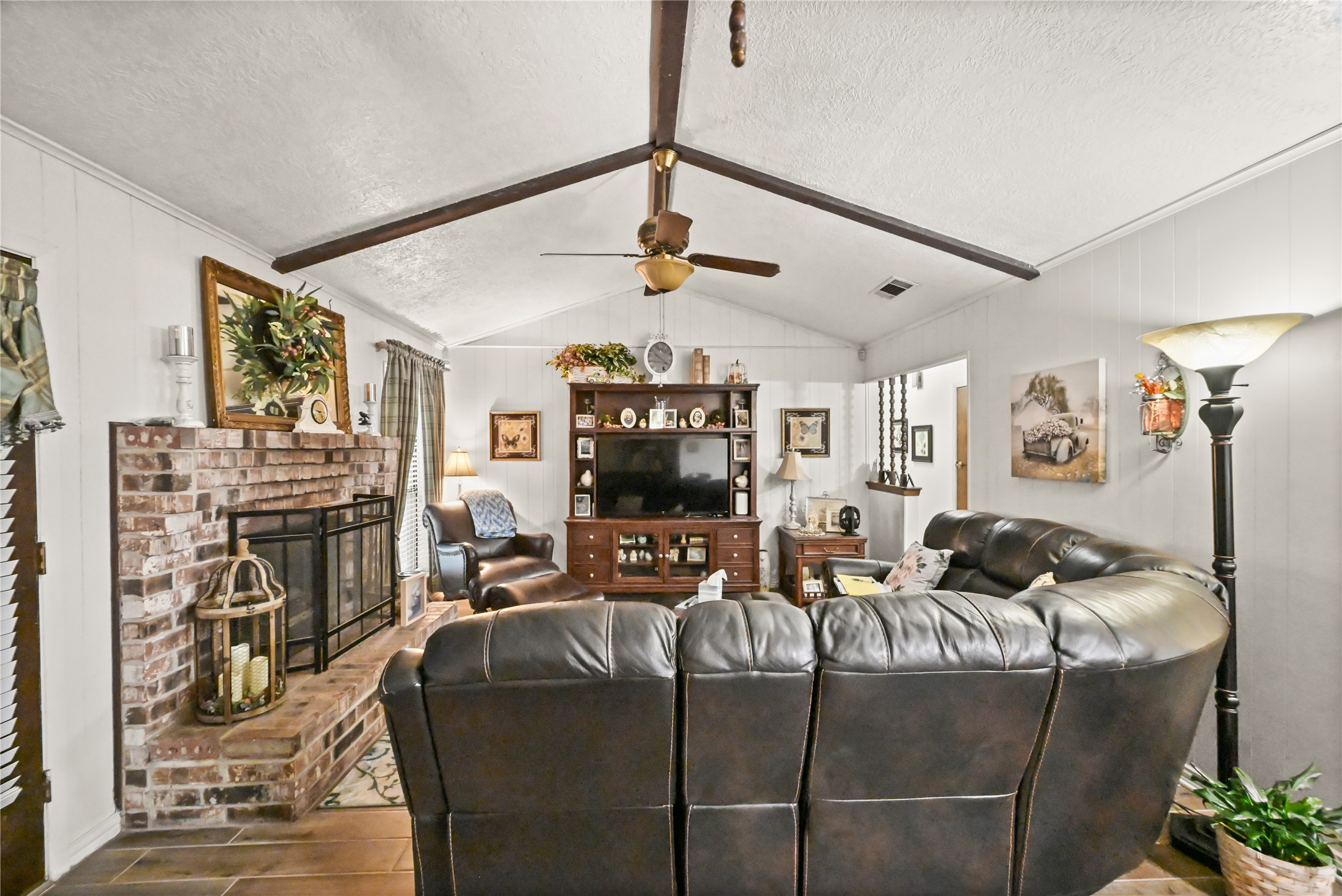 20135 Fox Grove Lane Humble, TX 77338 - Photo 8 of 34 a living room with fireplace furniture and a flat screen tv