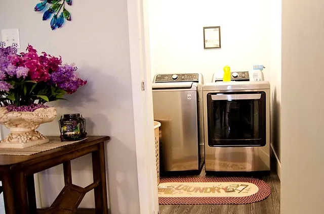 a view of a dining room with furniture and chandelier