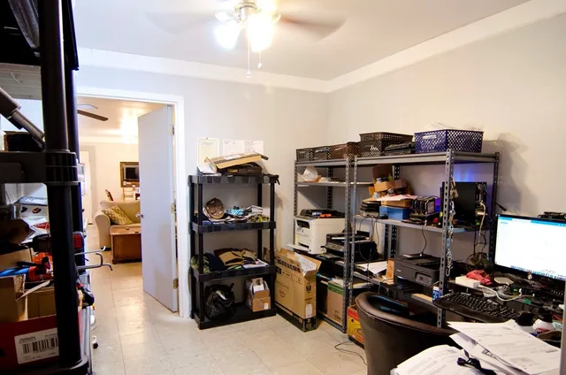 a living room with furniture a chandelier and a flat screen tv