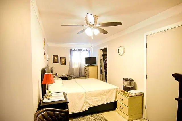 a bedroom with a bed and ceiling fan