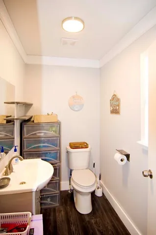 a bathroom with a granite countertop sink a toilet a shower and a mirror