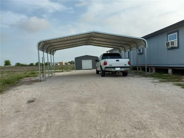 a kitchen with cabinets appliances a sink and a window