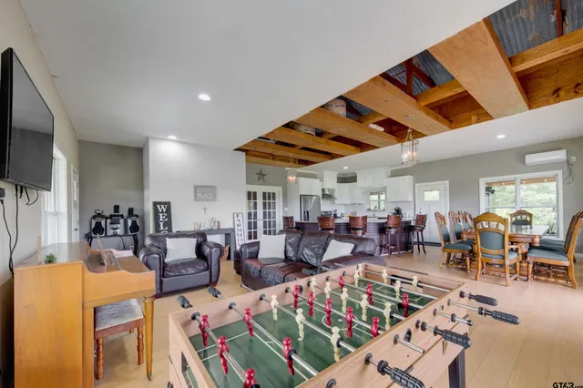 a living room with lots of furniture and kitchen view