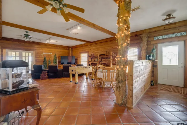 a room with lots of wooden furniture and a chandelier