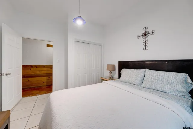 a bedroom with a bed and a ceiling fan