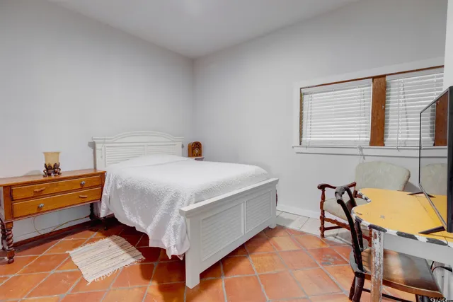 a bed room with a bed and chair