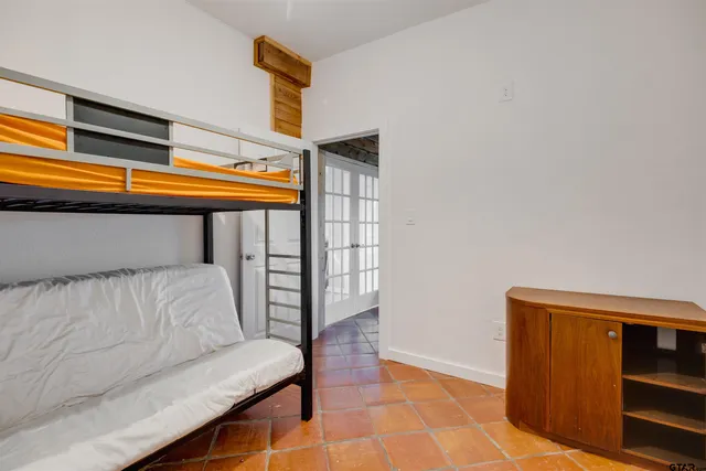 a hallway with a couch and a potted plant on it