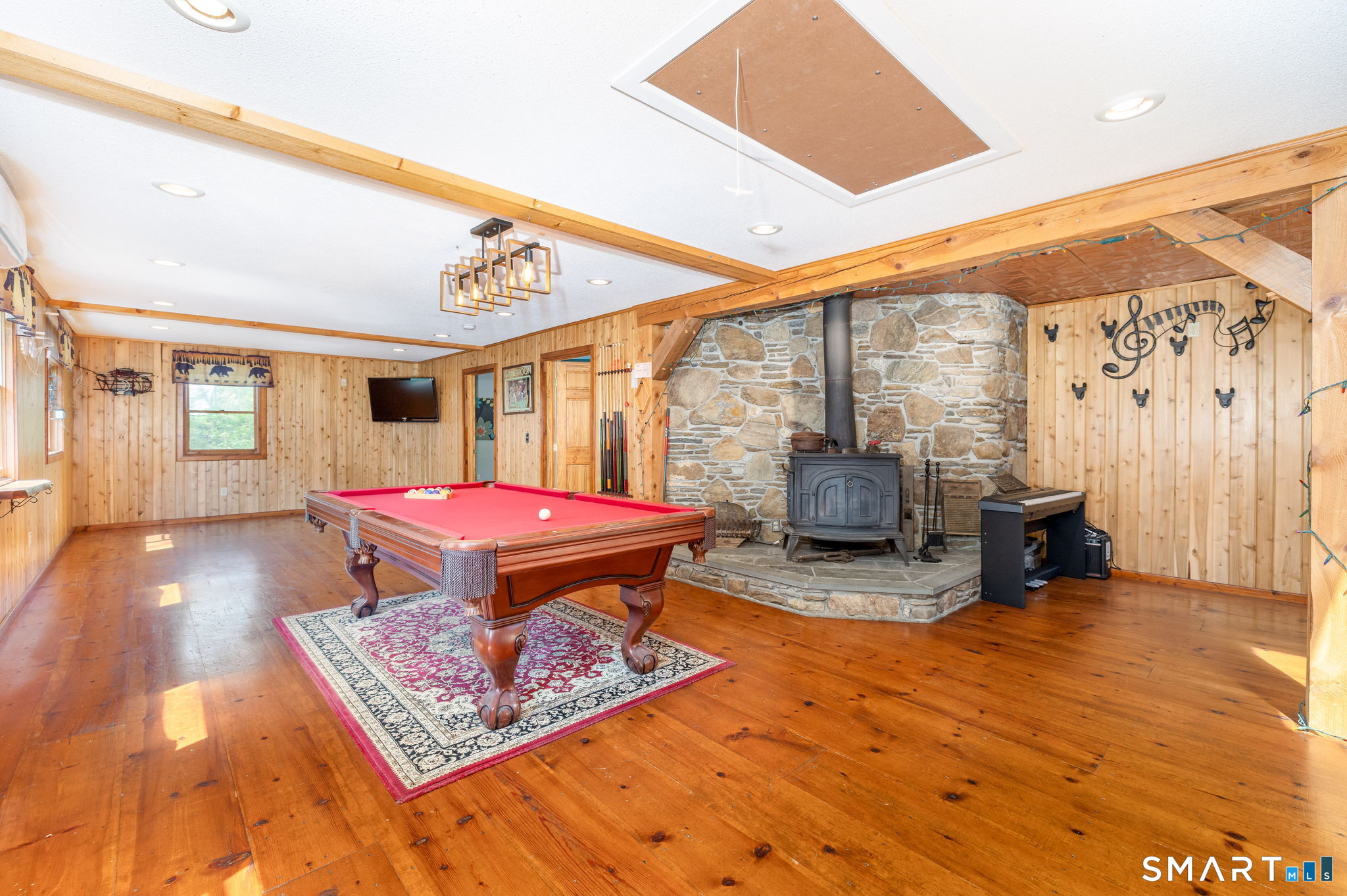 250 Center Hill Road Barkhamsted, CT 06063 - Photo 11 of 40 a living room with furniture a rug and a floor to ceiling window