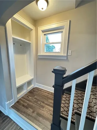 a view of a room with wooden floor