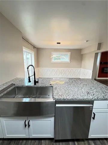 a kitchen with a sink and wooden cabinets