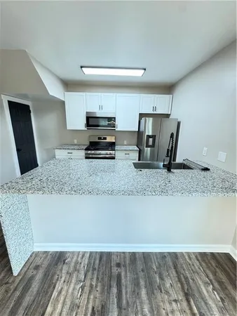 a kitchen with granite countertop a stove and a sink