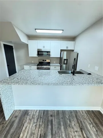 a kitchen with granite countertop a stove and a sink