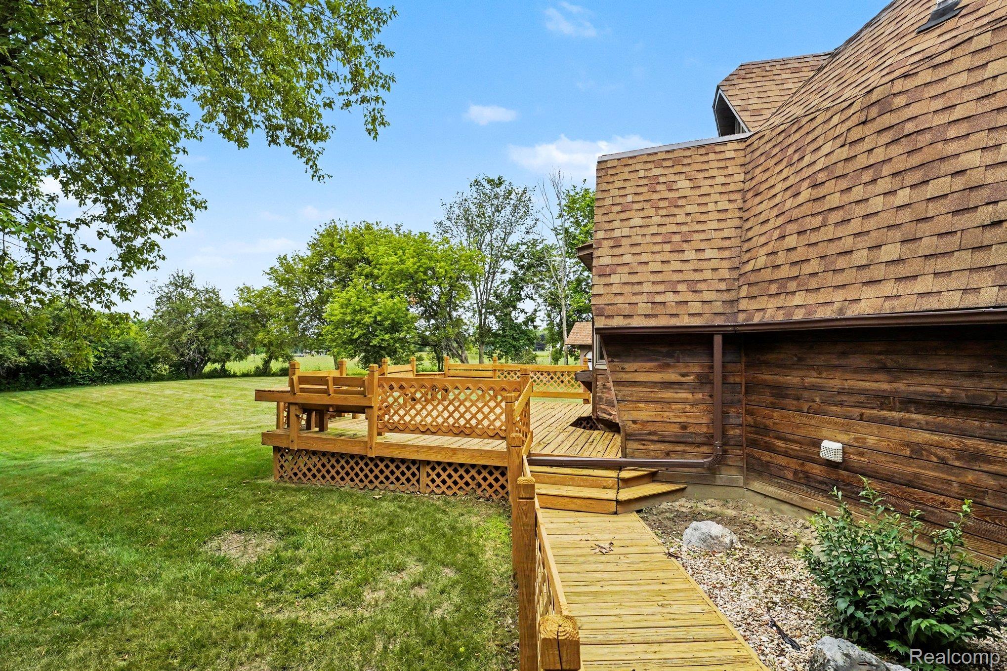 4425 North Henderson Road Davison, MI 48423 - Photo 35 of 43 Spacious outdoor deck with decorative lattice skirting and integrated bench seating