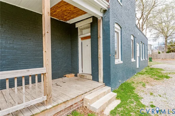 a view of a house with a yard and wooden fence