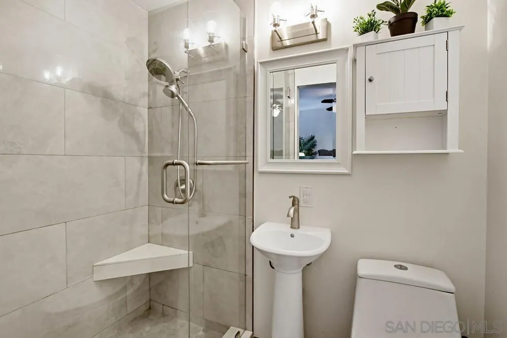 11038 Larkridge Street Santee, CA 92071 - Photo 17 of 44 a bathroom with a sink toilet and shower