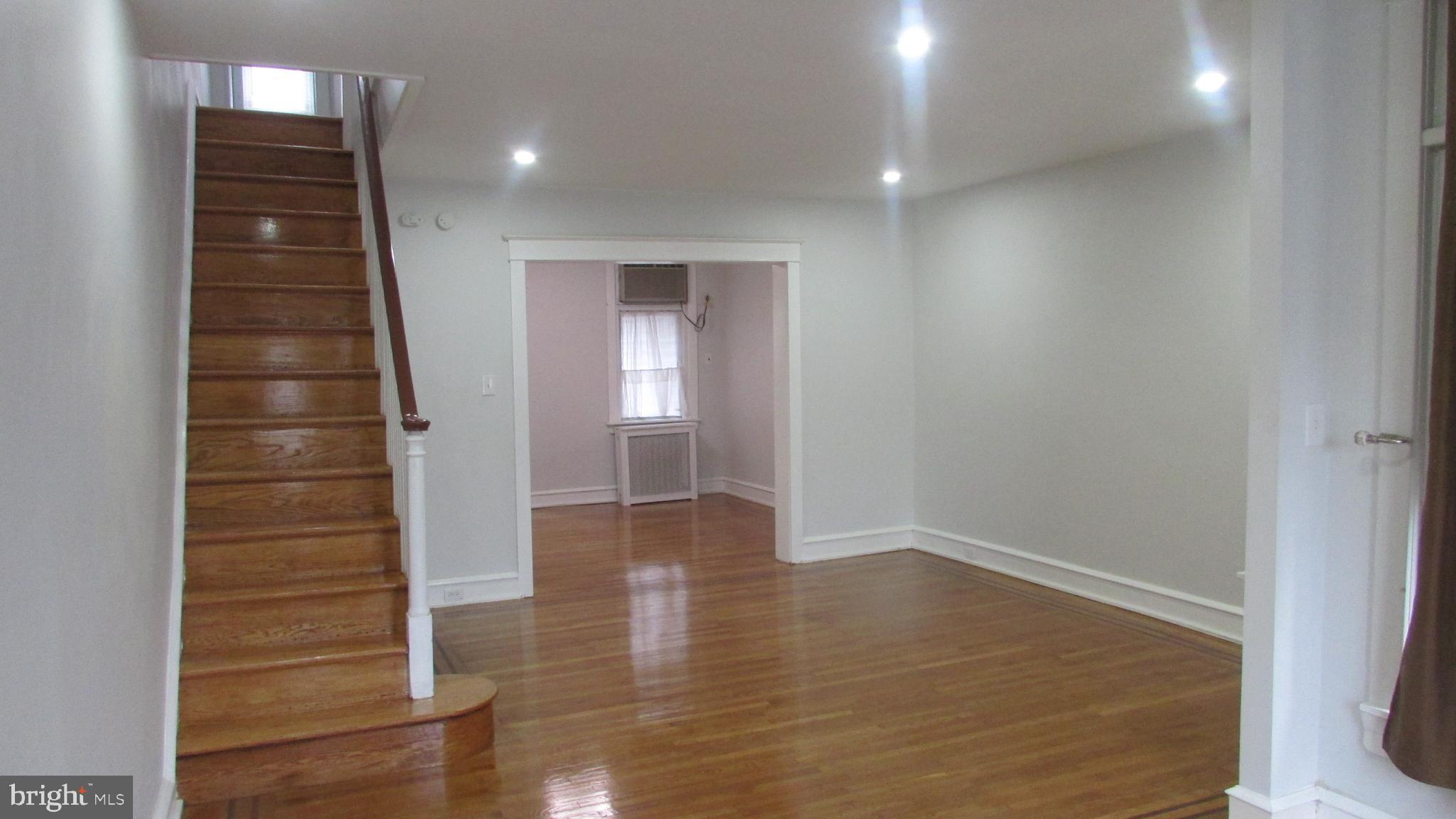5324 Horrocks Street Philadelphia, PA 19124 - Photo 5 of 25 an empty room with wooden floor and windows
