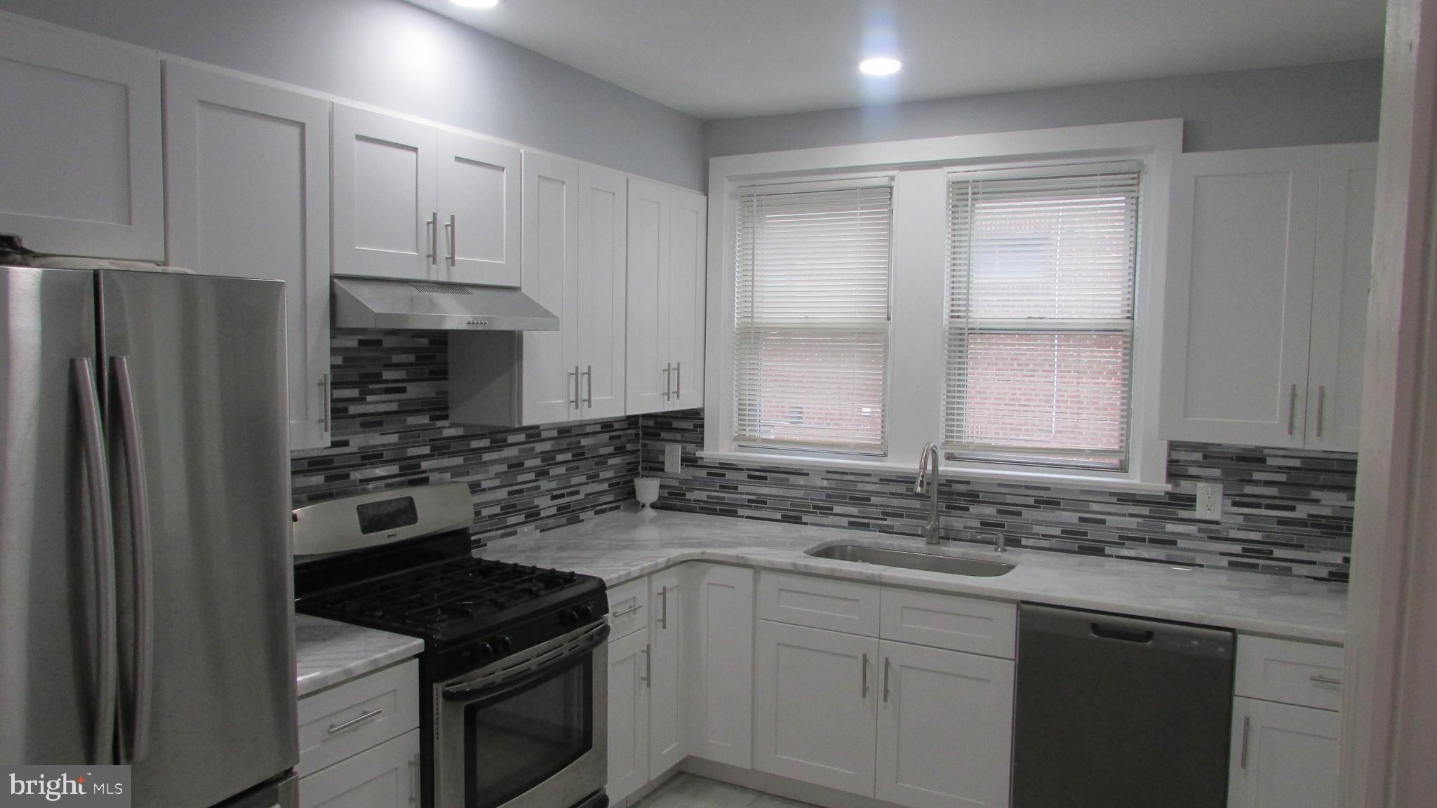 5324 Horrocks Street Philadelphia, PA 19124 - Photo 8 of 25 a kitchen with a sink stove and cabinets