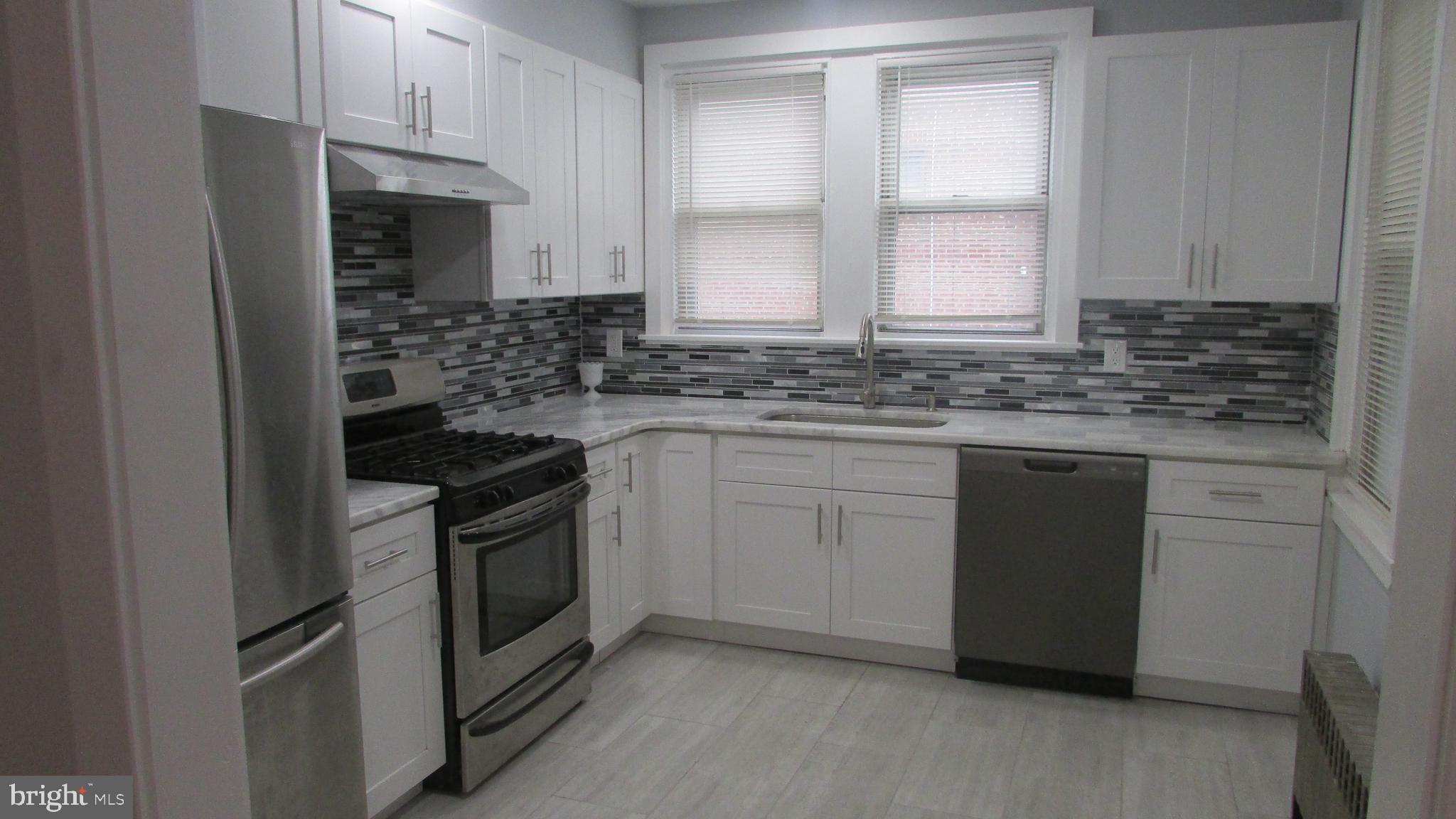 5324 Horrocks Street Philadelphia, PA 19124 - Photo 9 of 25 a kitchen with stainless steel appliances granite countertop a stove a sink and a refrigerator