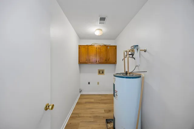 a view of hallway with stairs and a window