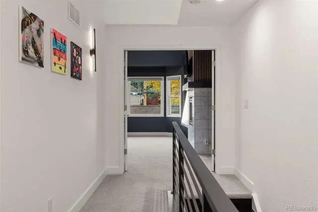 a view of a hallway with wooden floor and entryway
