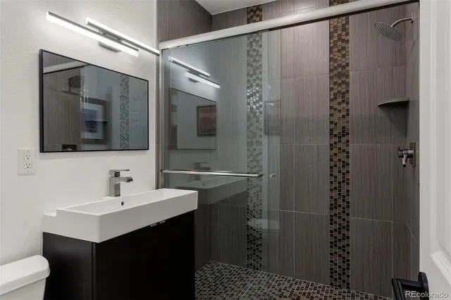 a bathroom with a sink a mirror and a shower