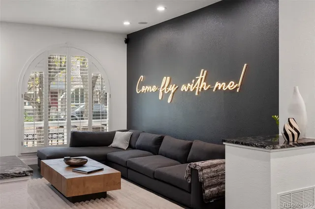 a living room with furniture and a large window