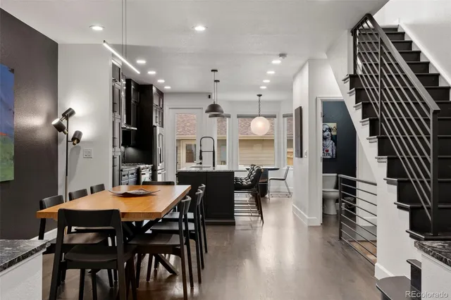a dining room with furniture and wooden floor