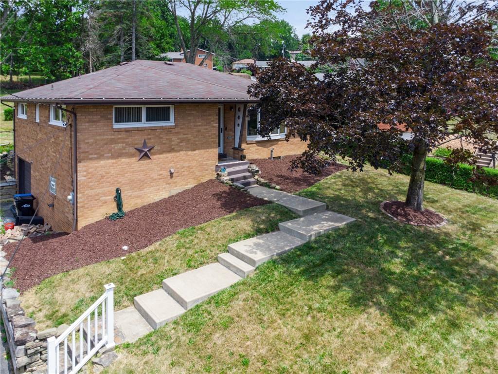 11401 McKee Road Irwin, PA 15642 - Photo 2 of 27 a front view of a house with garden