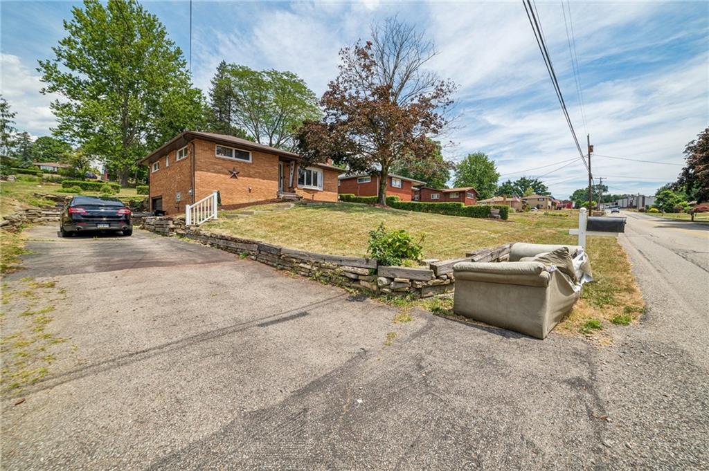 11401 McKee Road Irwin, PA 15642 - Photo 24 of 27 a view of a house with a yard and sitting area