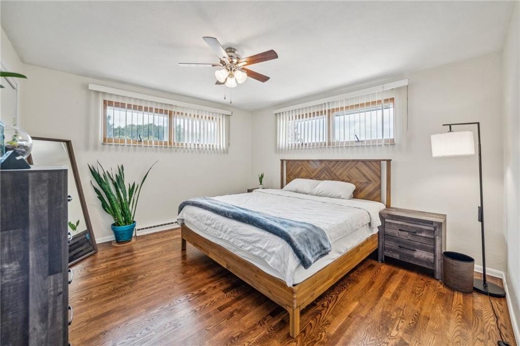 11401 McKee Road Irwin, PA 15642 - Photo 6 of 27 a bedroom with a bed and a potted plant