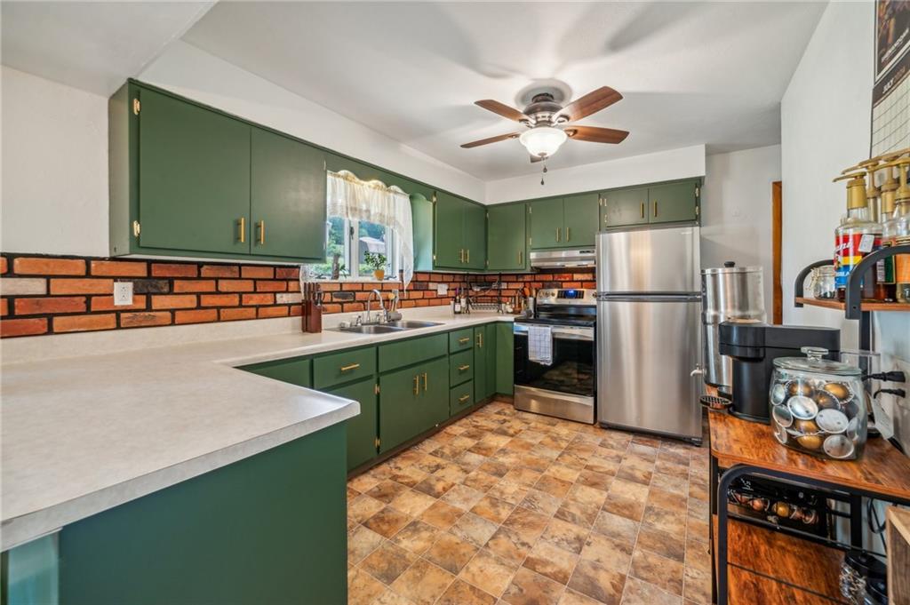 11401 McKee Road Irwin, PA 15642 - Photo 7 of 27 a kitchen with stainless steel appliances a sink stove and refrigerator
