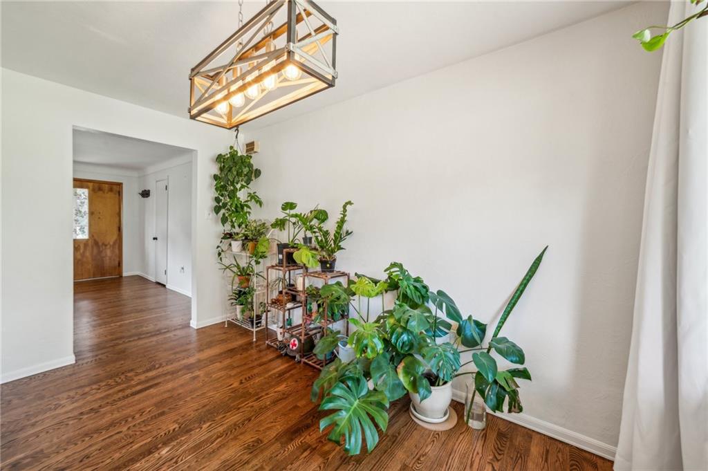 11401 McKee Road Irwin, PA 15642 - Photo 10 of 27 a view of a hallway with wooden floor and a potted plant